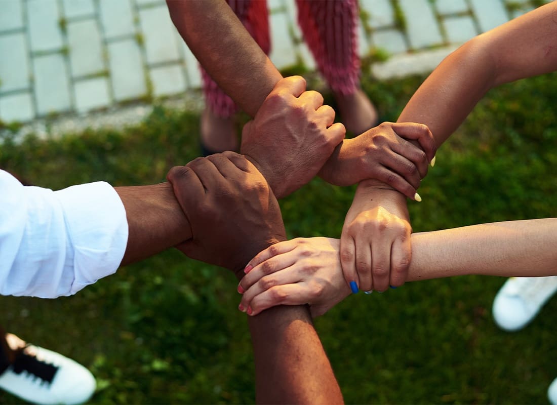 Community Involvement - Group of People Grasping Each Other's Wrists To Form a Circle