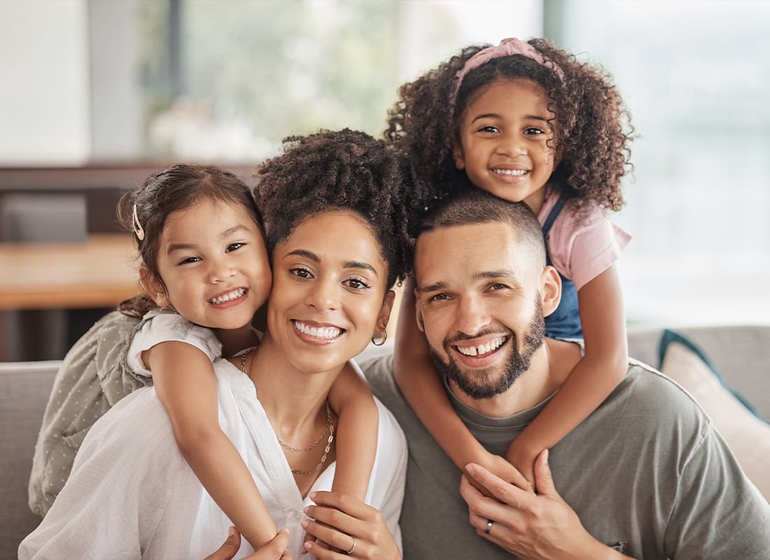 Personal Insurance - Young Happy Family Taking a Portrait Photo at Home on Their Sofa